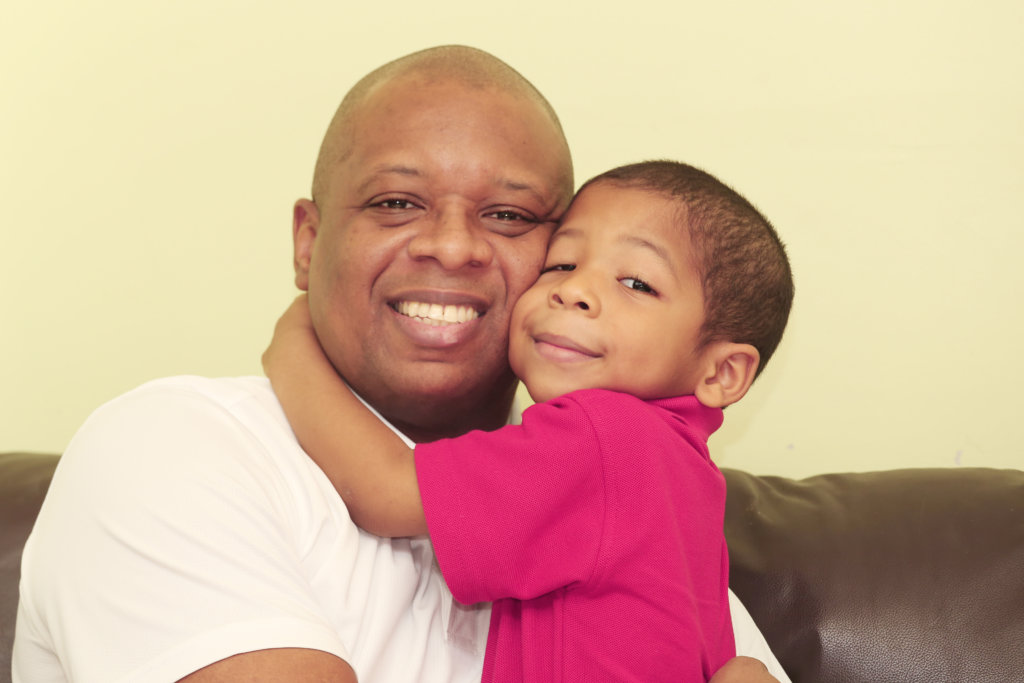 black-father-child-indoors-happy